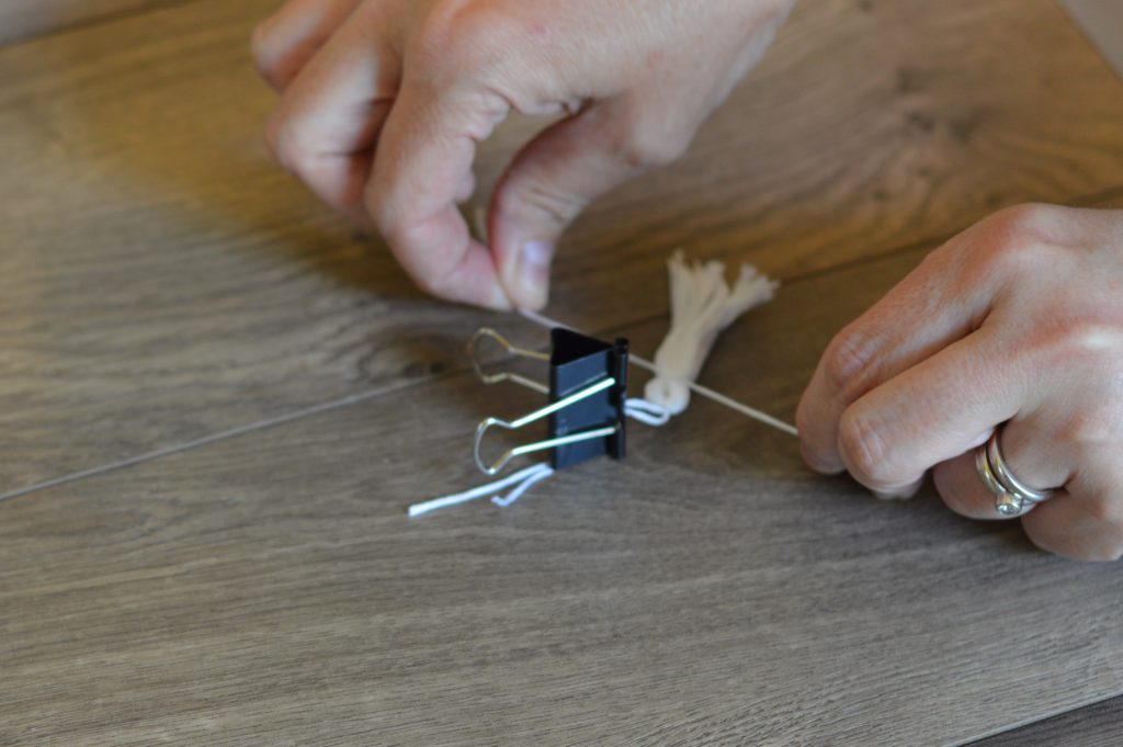 Binder clip holding floss